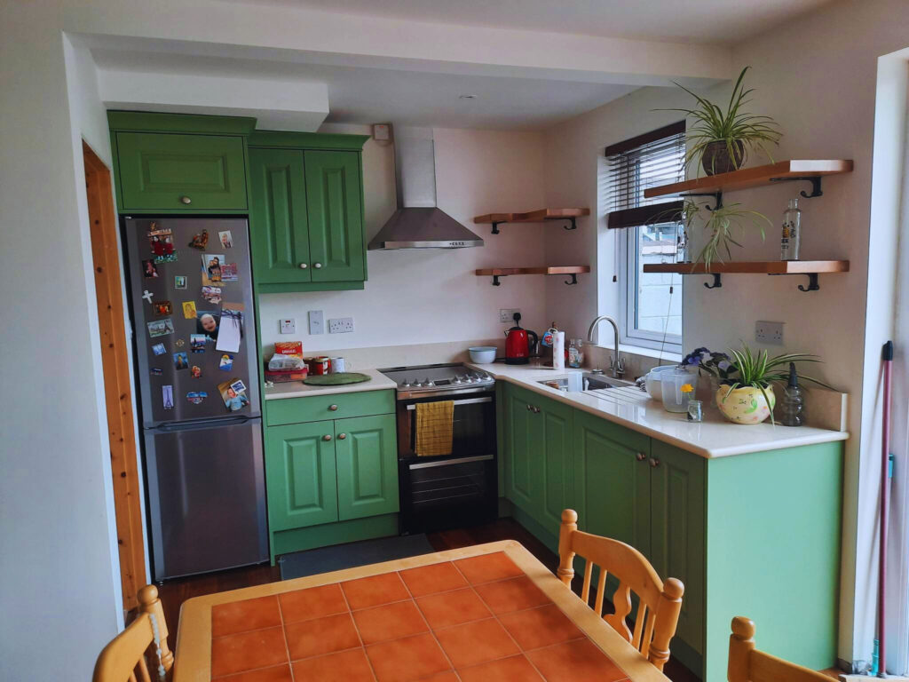 Kitchen units painted in grass green colour