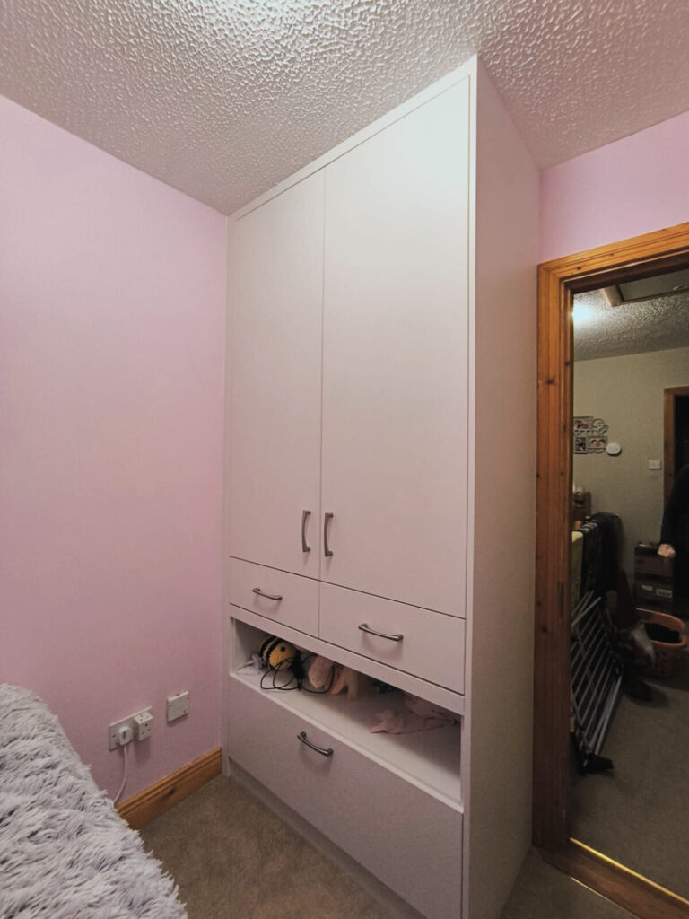 Custom wardrobe made for under stairs room.